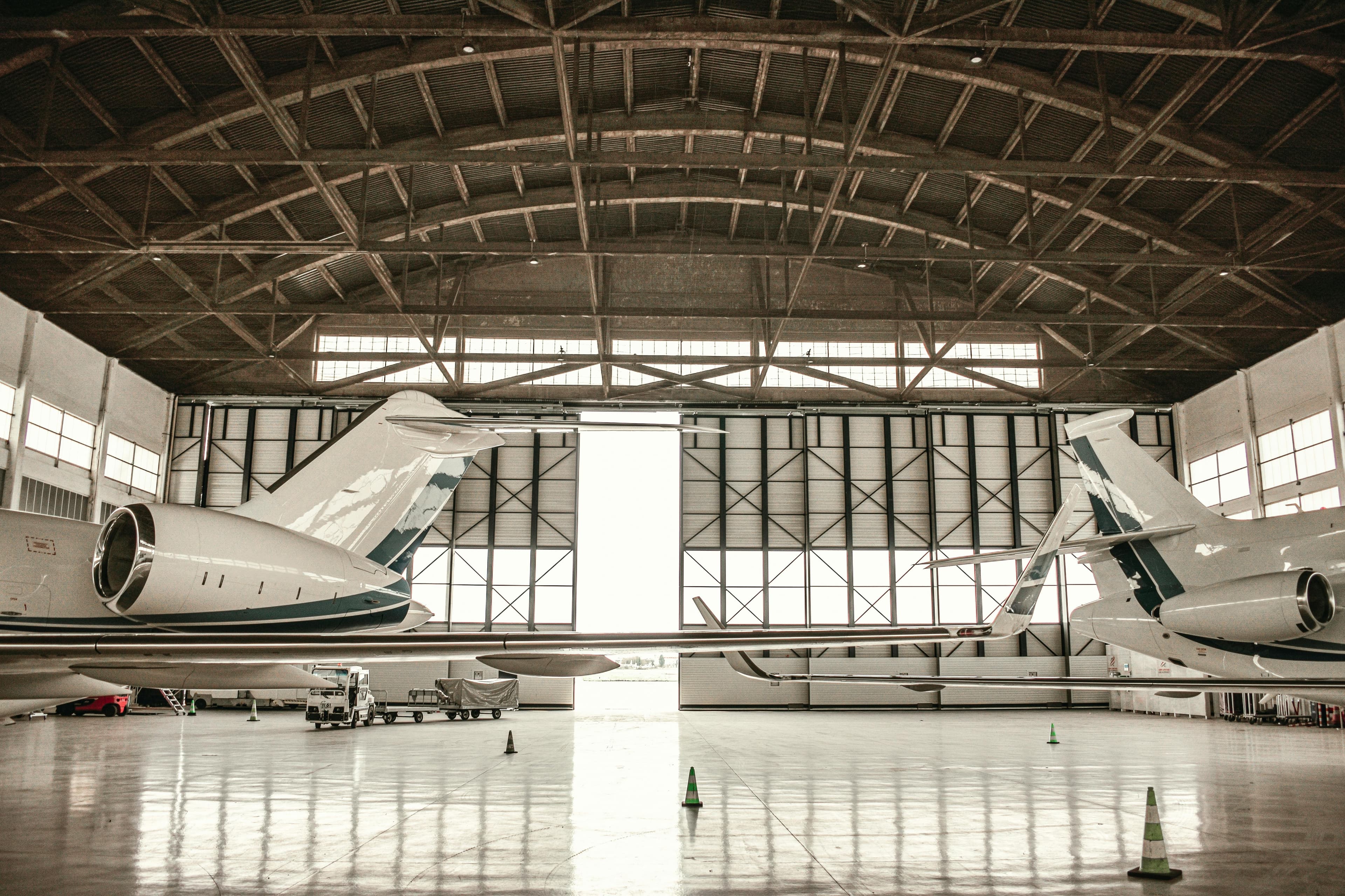 A midsize private jet on the ramp at a regional airport at golden hour with a single FBO building in the background