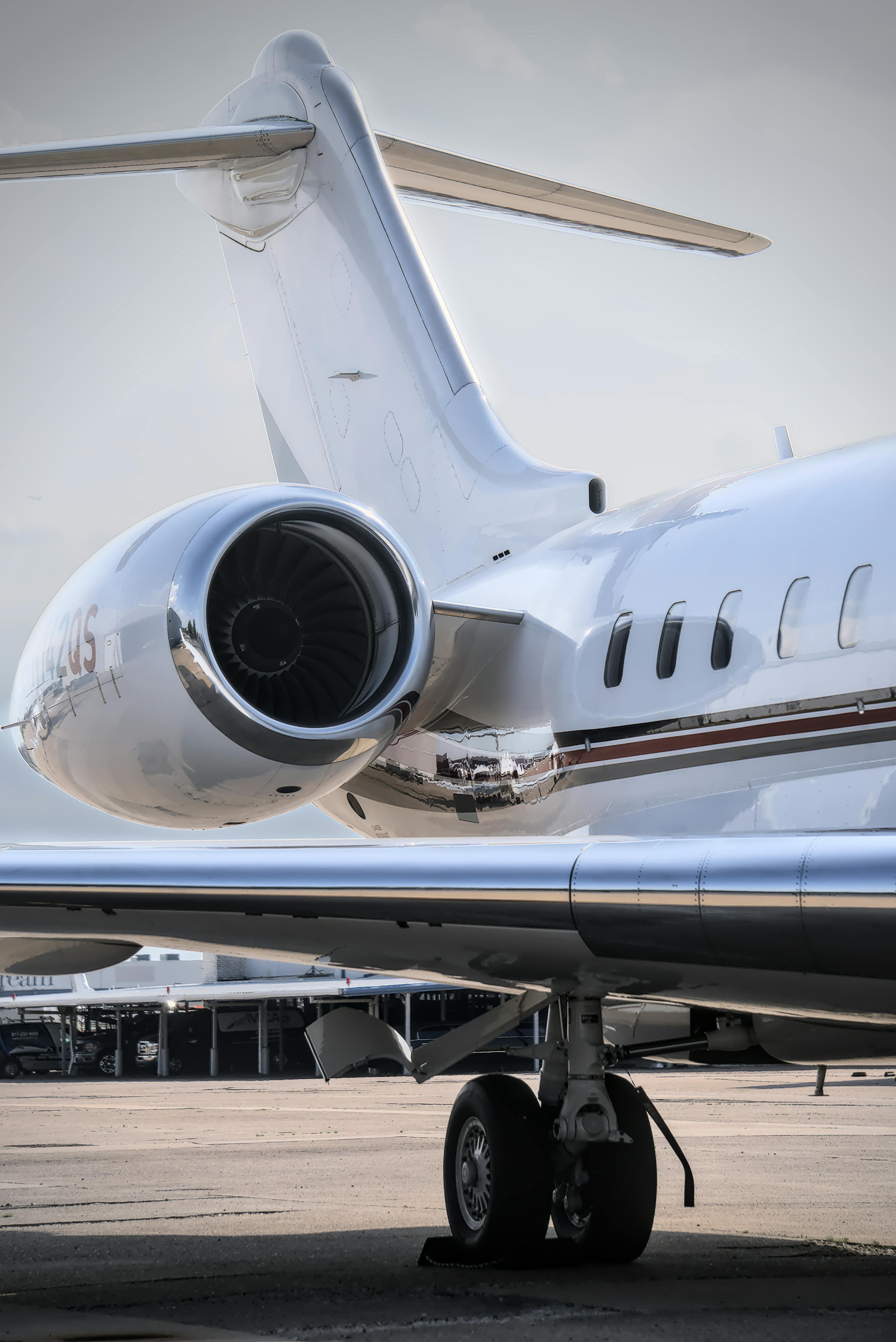 A light jet on the ramp at a South Florida executive airport at golden hour with palm trees in the background