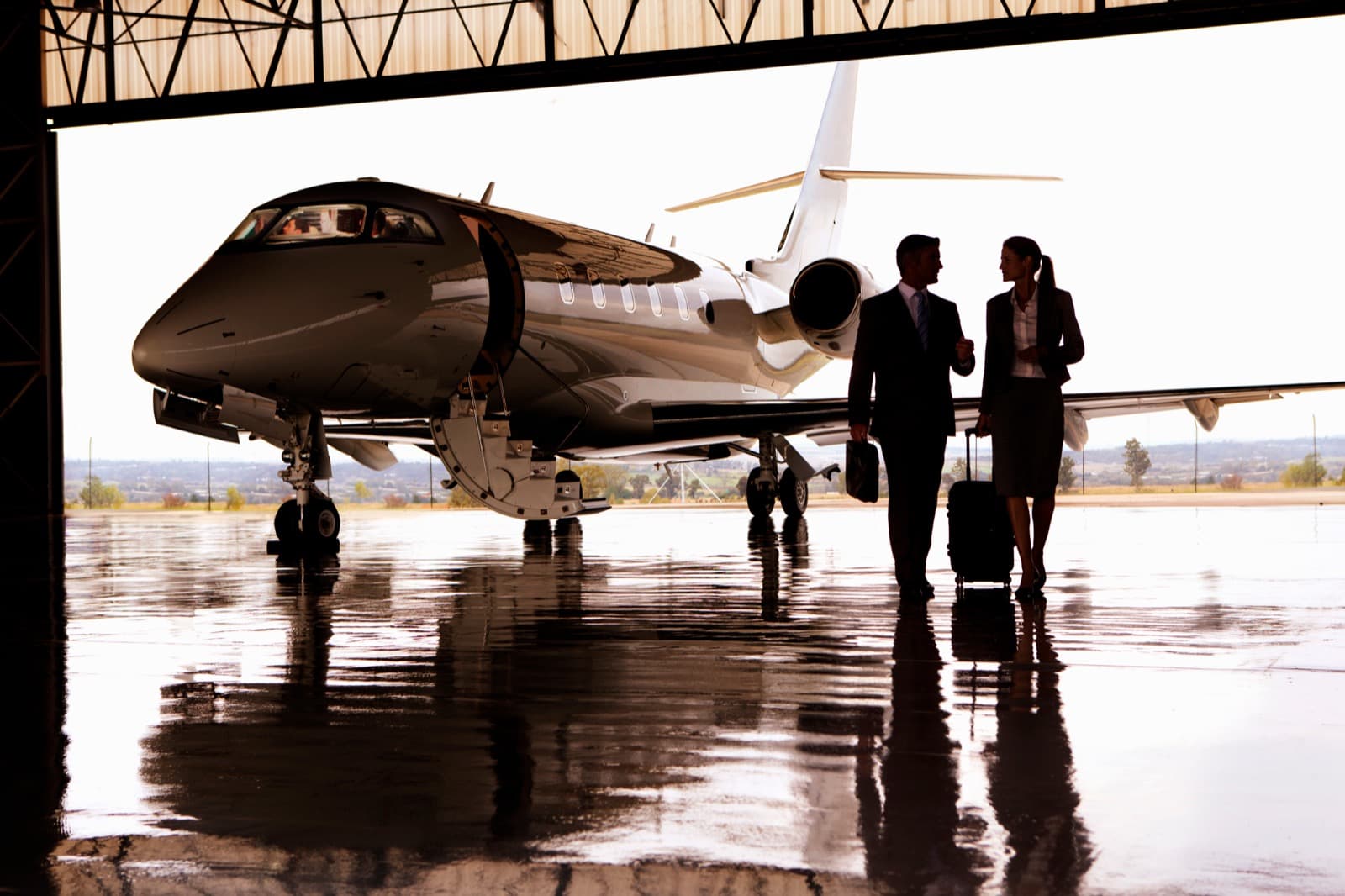 A light jet parked on a Louisville FBO ramp on a clear spring morning with crew preparing for departure