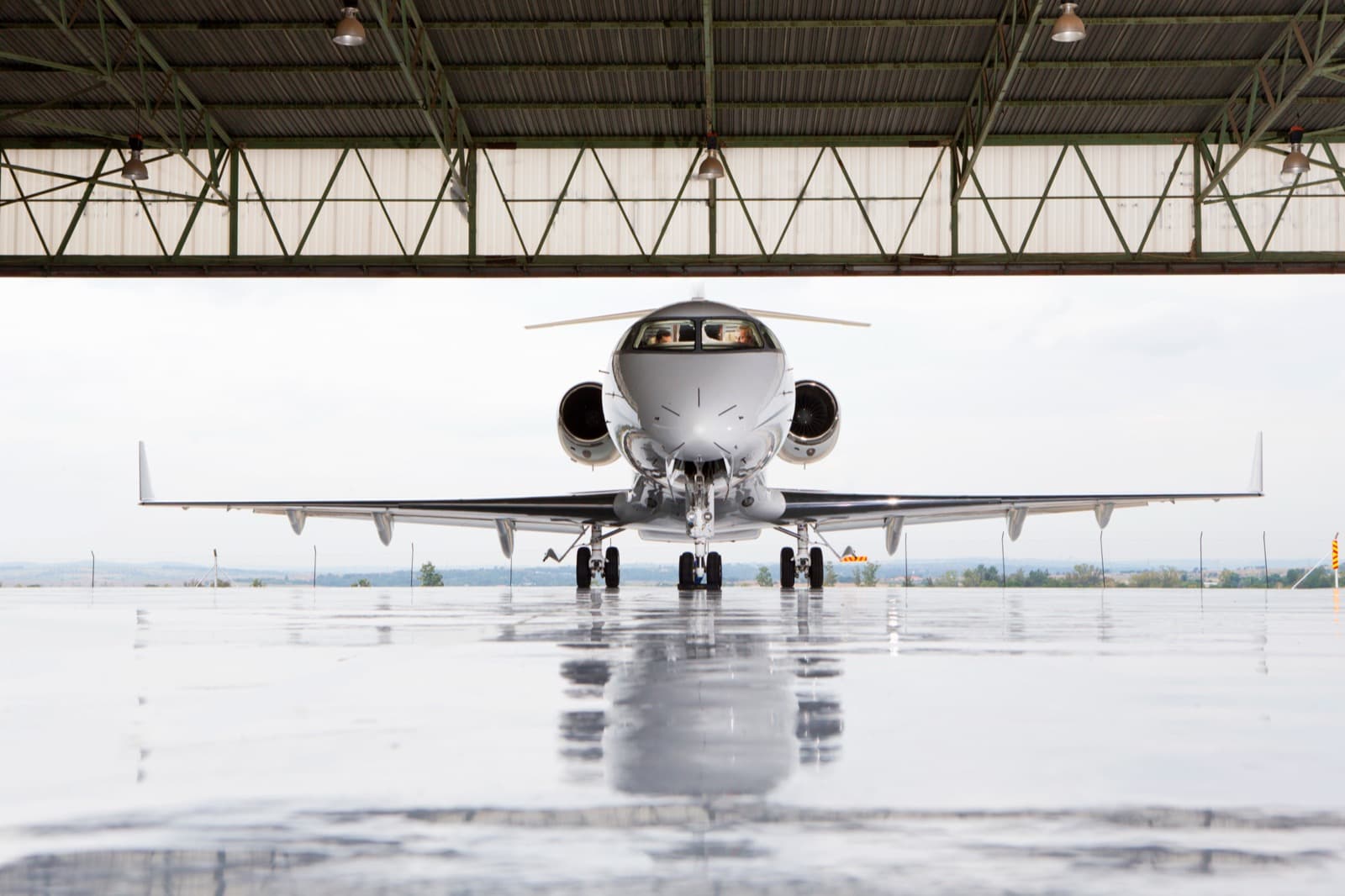 A midsize jet parked on a Scottsdale FBO ramp at sunrise with Camelback Mountain in the background