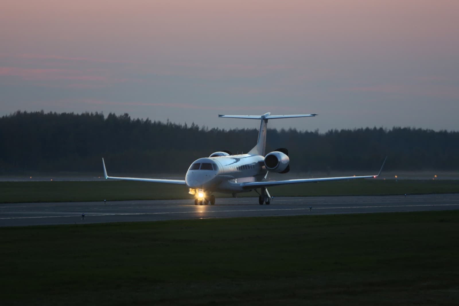 A heavy private jet on approach to Nice Côte d'Azur with the Mediterranean coastline below at golden hour